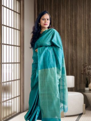Full-length front view of the Aqua Green Tussar Silk Saree showcasing vertical zari weaving and a graceful tissue pallu. The lightweight fabric enhances its elegant drape.