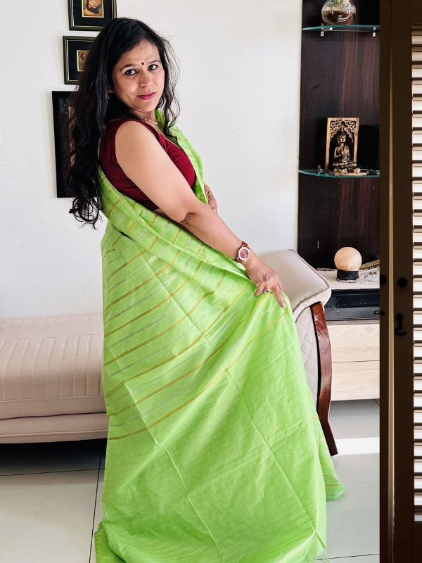 Gold and silver zari detailing on parrot green Tussar silk saree